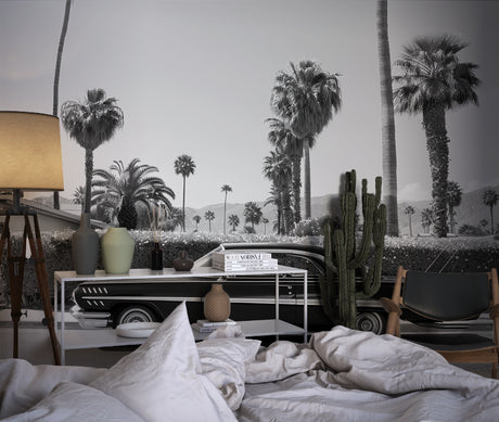Vintage car wallpaper creating drama in modern living room with black and white Palm Springs scene
