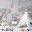 Safari nursery wallpaper with hot air balloons displayed in a bright, modern nursery with white furniture
