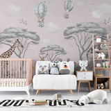 Pink safari wallpaper creating a cozy reading nook in a children's bedroom