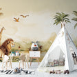 Safari wallpaper mural styled in modern living room with natural light showing African animals and palm trees