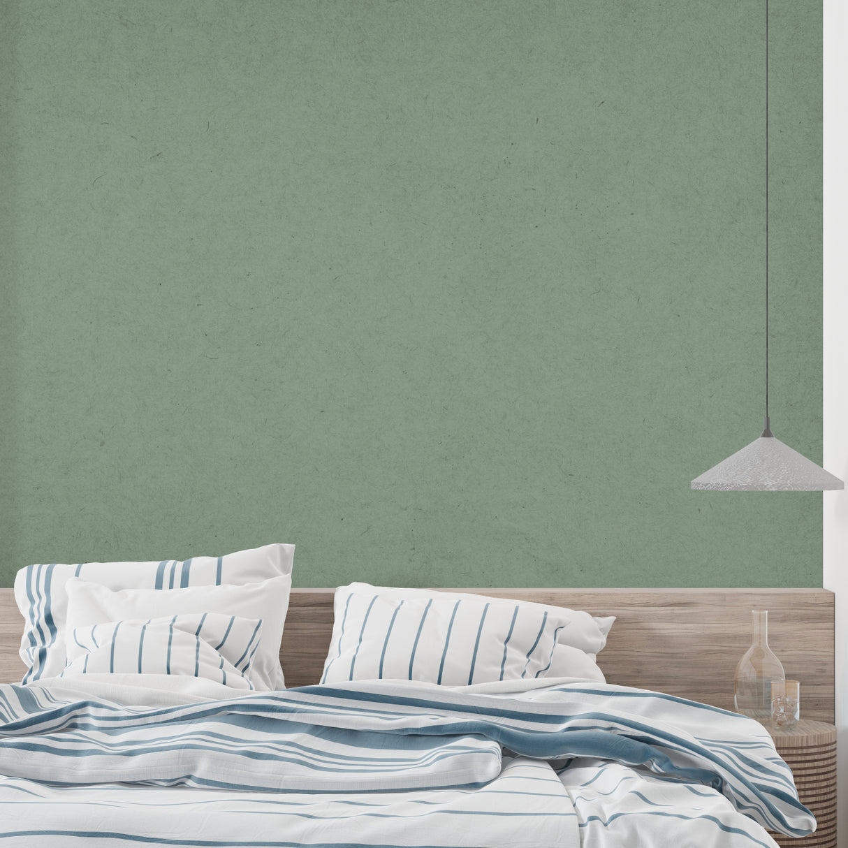 Minimalist sage green wall mural creating calm atmosphere in bedroom setting