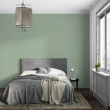 Sage green minimalist wallpaper in modern living room creates serene atmosphere