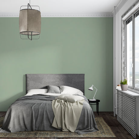 Sage green minimalist wallpaper in modern living room creates serene atmosphere