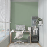 Contemporary bedroom with sage green wall mural showing calm minimal design