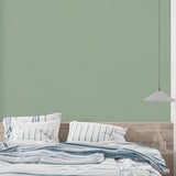 Home office featuring modern sage green wallpaper with minimal aesthetic