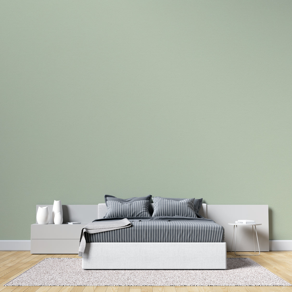 Home office space with calming sage green wallpaper and wooden accents