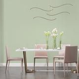 Dining room showcasing modern sage green wall design with pendant lighting