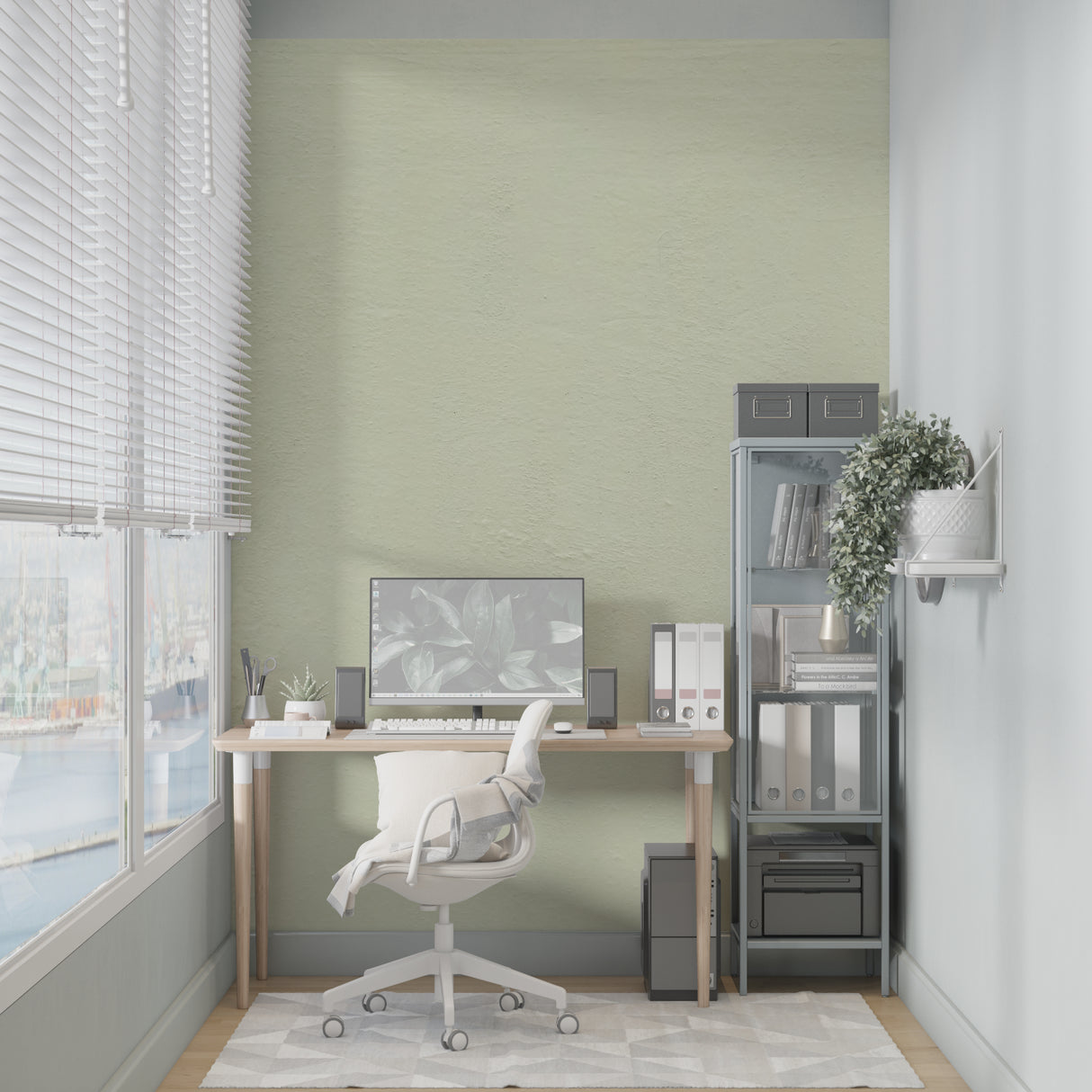 Home office space with sage green minimalist wallpaper creating a focused environment