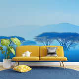 African savanna wallpaper creating a peaceful atmosphere in a modern living room with blue misty tree silhouettes