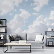 Cloud wall mural creates an airy atmosphere in a modern living room with natural light streaming through windows