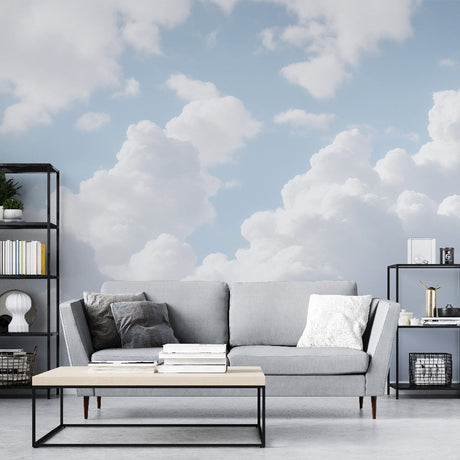 Cloud wall mural creates an airy atmosphere in a modern living room with natural light streaming through windows