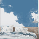 Blue sky mural creating airiness in a small reading nook