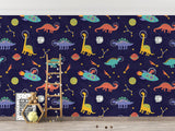 Kids reading nook with the dinosaur space wallpaper, showing how it creates a cozy story corner