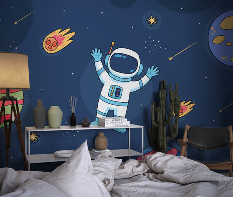 Space exploration wallpaper shown in modern kids bedroom with blue accent wall and floating astronaut design