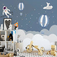 Space themed wallpaper with astronaut and hot air balloons creating magic in a modern nursery with soft lighting