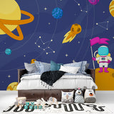Playroom transformed with space theme wallpaper showing floating astronaut and colorful planets