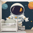 Space themed wallpaper with astronaut and planets shown in a bright modern nursery, creating a magical atmosphere