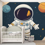 Space themed wallpaper with astronaut and planets shown in a bright modern nursery, creating a magical atmosphere