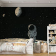 Space Mural Wallpaper with astronaut design shown in modern kids bedroom, creating an inspiring atmosphere for young dreamers