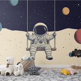 Space themed wallpaper with swinging astronaut shown in a modern kids bedroom, creating a magical atmosphere with floating planets