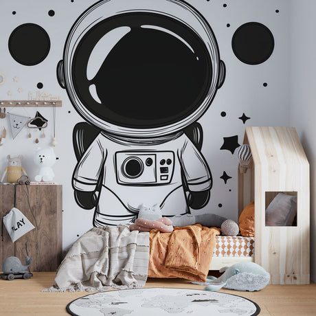 Black and white astronaut wallpaper creating a modern accent wall in a minimalist teen bedroom with floating space elements
