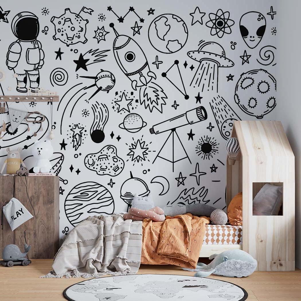 Black and white space mural in playroom with astronomy sketches