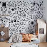 Black and white space mural in playroom with astronomy sketches