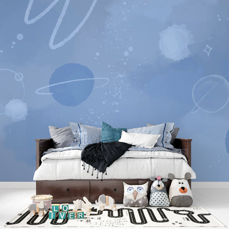 Space mural wallpaper creating cosmic atmosphere in modern kids bedroom with blue galaxy and planets design