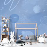 Blue galaxy wallpaper transforming playroom into space adventure zone with floating planets