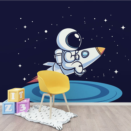 Space wallpaper with cartoon astronaut and rocket bringing joy to a modern kids bedroom with blue walls and wooden furniture