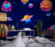 Space wallpaper mural bringing cosmic wonder to a modern kids bedroom with glowing planets and UFOs