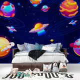 Playroom transformed with space themed wallpaper featuring colorful galaxy and floating spaceships