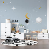 Moon and stars wallpaper adding magic to a teen's bedroom space