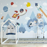 Kids study area with mountain and space wallpaper showing planets and stars