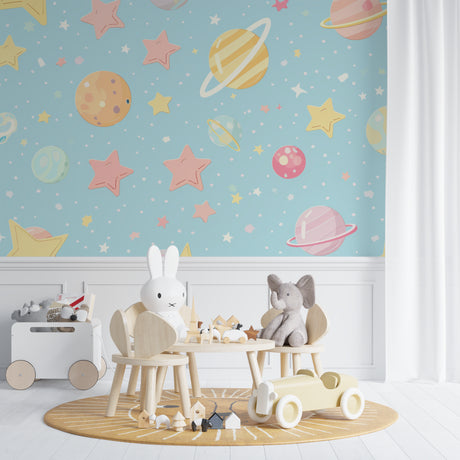 Space theme wallpaper in modern nursery with white furniture showing soft pastel planets and stars