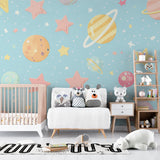Reading nook with space theme wall mural creating cozy atmosphere