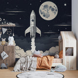 Space rocket wallpaper mural shown in modern kids bedroom with blue accents and star-themed decor