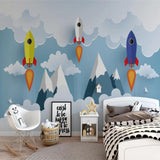 Rocket wallpaper mural displayed in a playful nursery setting with white furniture