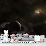 Saturn galaxy mural wallpaper transforming a kid's gaming room into a cosmic adventure