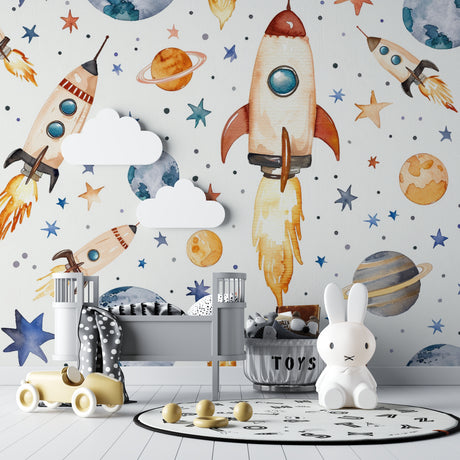 Space theme wallpaper in modern nursery showing watercolor rockets and planets creating a dreamy atmosphere