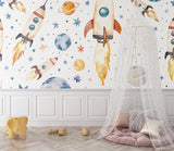 Playroom decorated with space rocket wallpaper showing floating planets and stars