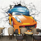Orange 3D car wallpaper creating dramatic effect in modern gaming room with LED lighting and contemporary furniture