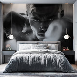Black and white boxing wallpaper creating dramatic impact in modern home gym with training equipment