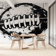 Football wall mural creating a striking focal point in a modern living room with minimalist furniture