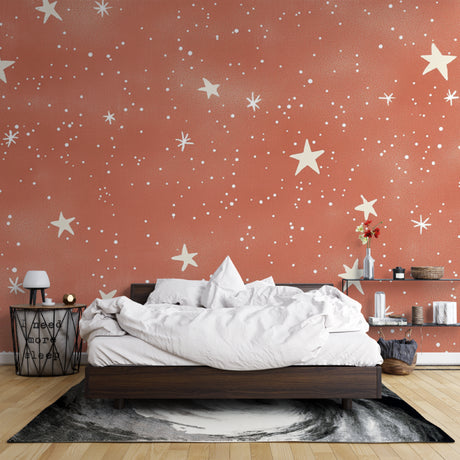 Terracotta star wallpaper in a cozy bedroom creating a warm, dreamy atmosphere