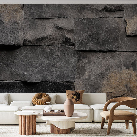 Black stone effect wallpaper creating dramatic accent wall in modern living room with leather furniture and metal accents