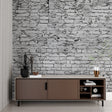 Grey stone wallpaper in modern living room creating industrial charm with natural light