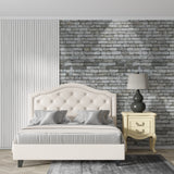 Industrial grey brick mural in office space showing depth and texture