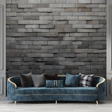 Modern grey stone wall mural in contemporary living room with minimal furniture and natural light
