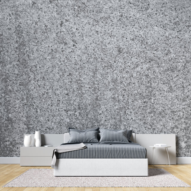 Modern grey stone wallpaper creating depth in a minimalist living room with natural light